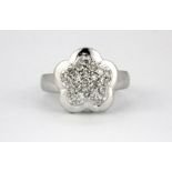 A 14ct white gold (stamped 585) diamond set flower shaped ring, (M).