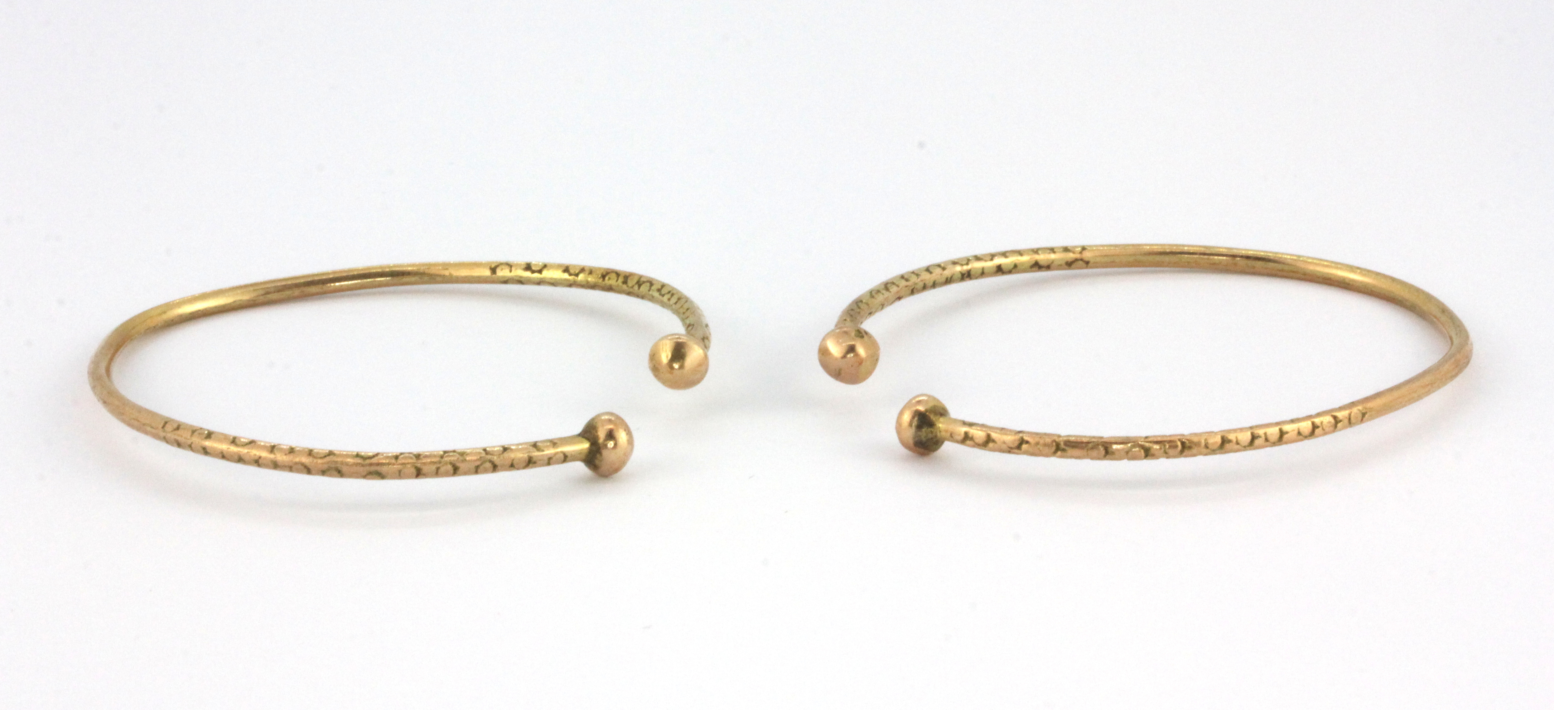 Two yellow metal (tested minimum 14 carat gold) adjustable baby bangles.