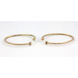 Two yellow metal (tested minimum 14 carat gold) adjustable baby bangles.