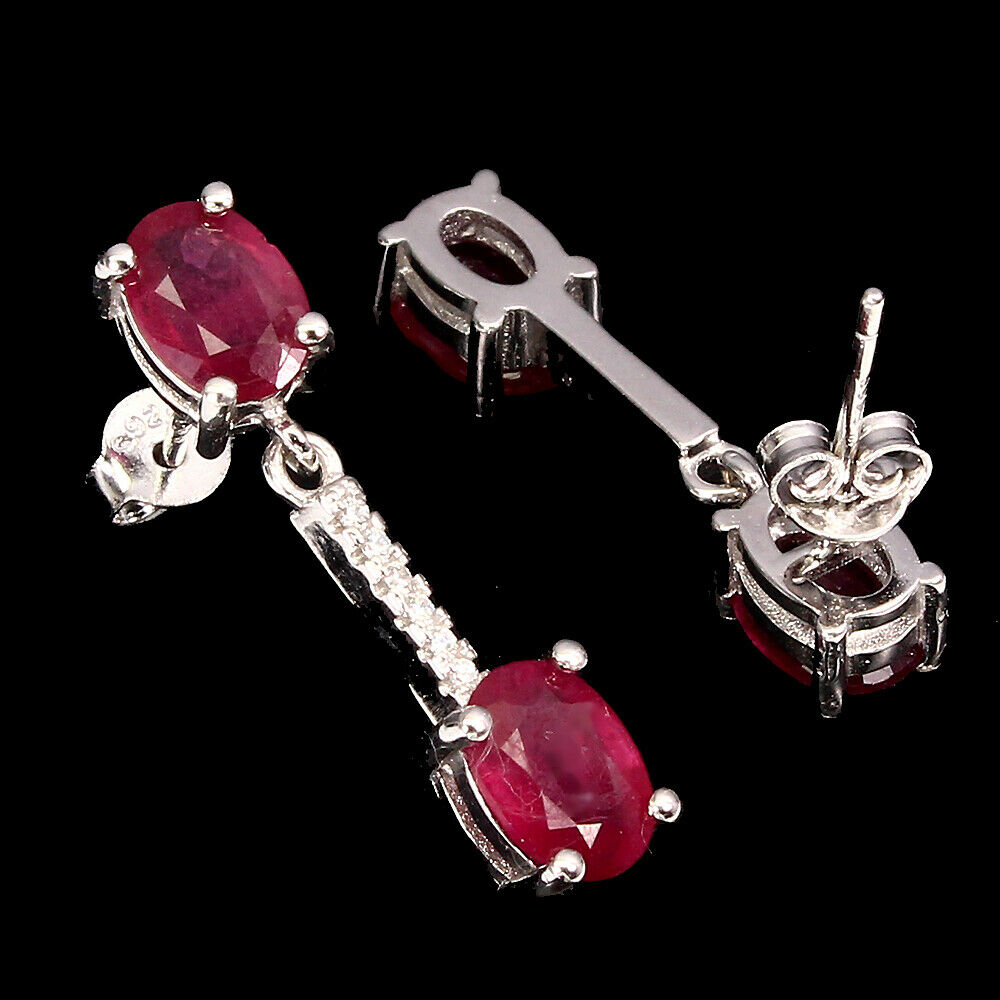 A pair of 925 silver drop earrings set with oval cut rubies and white stones, L. 2.5cm. - Image 2 of 2