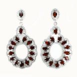 A pair of 925 silver drop earrings set with pear and oval cut garnets and white stones, L. 6cm.