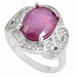A 925 silver ring set with a large oval cut ruby and white stones, (Q).