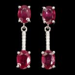A pair of 925 silver drop earrings set with oval cut rubies and white stones, L. 2.5cm.