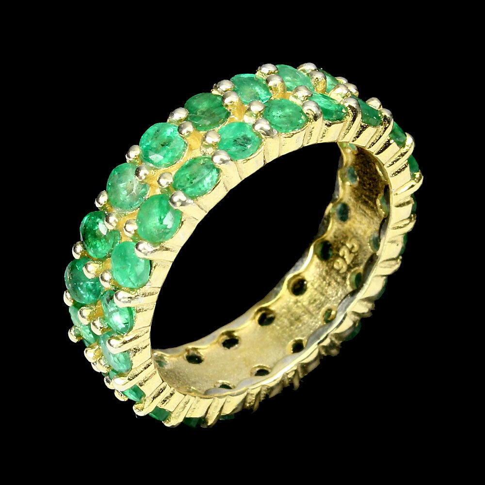 A 925 silver gilt two row full eternity ring set with emeralds, (O).