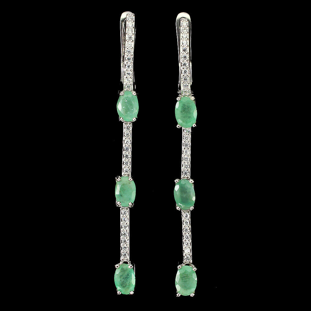 A pair of 925 silver drop earrings set with oval cut emeralds and white stones, L. 5.7cm.