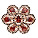 A 925 silver rose gold gilt ring set with garnets and black spinels, (O).