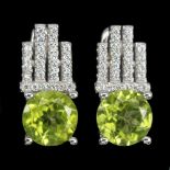 A pair of 925 silver earrings set with round cut peridot and white stones, L. 1.5cm.