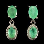 A pair of 925 silver drop earrings set with oval cut emeralds and white stones, L. 1.7cm.