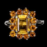 A 925 silver ring set with an emerald cut citrine surrounded by round cut citrines, (N).