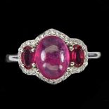 A 925 silver ring set with three cabochon cut rubies and white stones, (O).