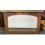 A early 20th Century art nouveau hammered copper covered over mantle mirror, W. 125cm, H. 70cm