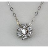 An 18ct white gold (stamped 750) diamond set flower shaped necklace, L. 36cm.