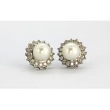 A pair of 18ct white gold (stamped 750) cluster earrings set with pearls and brilliant cut diamonds,