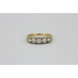 A yellow metal (tested 18ct gold) ring set with five brilliant cut diamonds, approx. 1ct overall, (