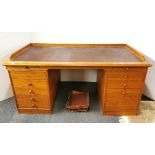 A large vintage leather topped teak desk and four filing trays, desk W. 167cm, D. 89cm, H. 74cm.