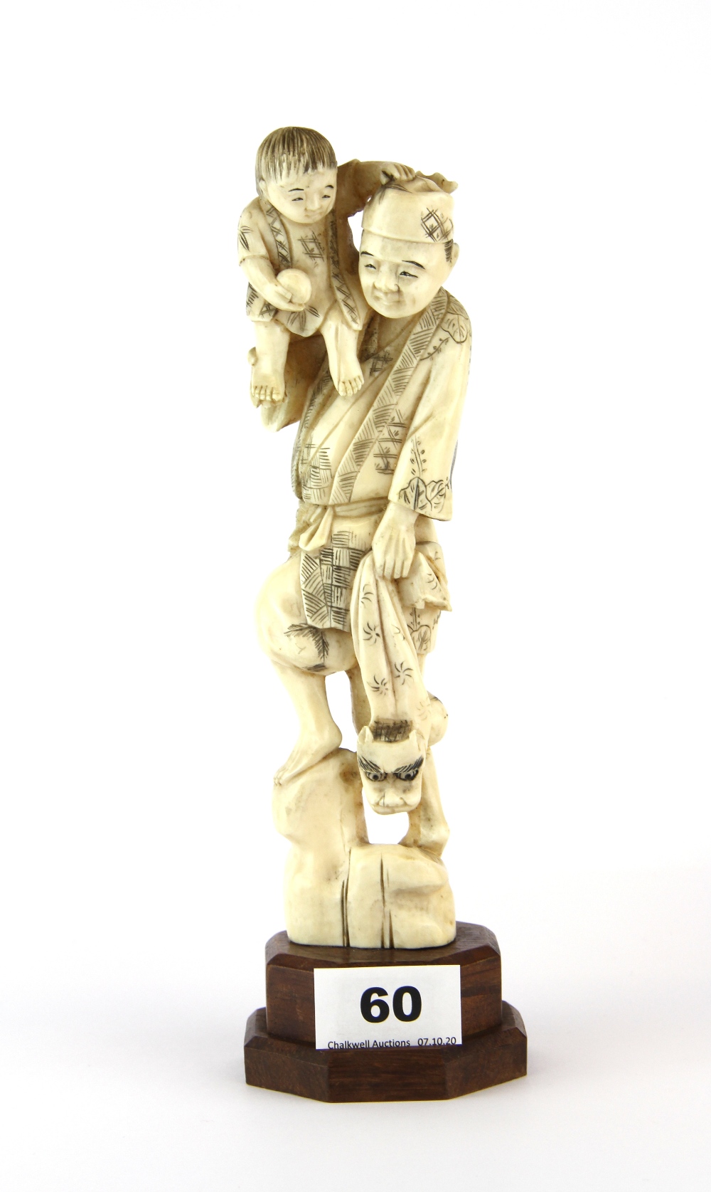 A 19th Century carved Japanese ivory figure on a later wooden stand, L. 25cm.