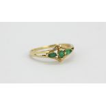 A 9ct yellow gold emerald and diamond set ring, (M).