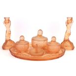 An Art Deco peach glass dressing table set decorated with mermaids, tray W. 35cm candlestick H.