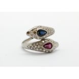 A white metal (tested high carat gold) ring set with ruby, sapphire and brilliant cut diamonds, (