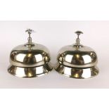 Two silvered metal shop counter bells, Dia. 14cm, H. 12cm.