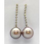 A pair of 18ct white gold (stamped 18k) drop earrings set with pink pearls and brilliant cut