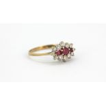A 9ct yellow gold ruby and diamond set cluster ring, (M.5).