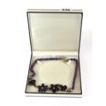 A boxed silver, amethyst and cultured pearl necklace.