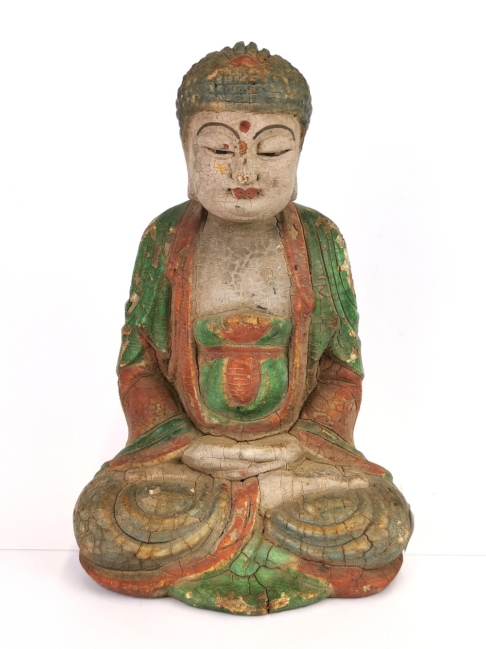 A Chinese painted carved wooden figure of a seated Buddha, H. 26cm.