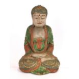 A Chinese painted carved wooden figure of a seated Buddha, H. 26cm.