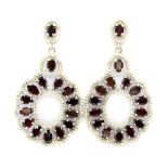 A pair of 925 silver drop earrings set with pear and oval cut garnets and white stones, L. 6cm.