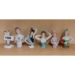 A group of five porcelain half dolls and pair of legs, tallest 8cm.