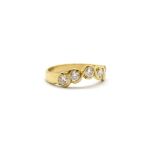 An 18ct yellow gold ring set with five brilliant cut diamonds, (P.5).