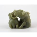 A fine Chinese carved olive green nephrite Jade model of two horses with strings of cash, 6 x 4.5