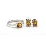 A matching pair of 925 silver stud earrings and ring set with cushion cut citrine, (P).