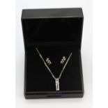 A suite of 9ct white gold diamond set earrings and matching pendant and chain.