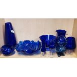 A group of mixed blue glassware.