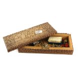 A 19th Century Indian carved wooden box and mixed military badge and button contents.