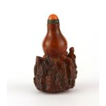 An unusual Chinese carved water buffalo horn snuff bottle decorated with immortals and with a gilt