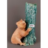 A Bretby vase of a bear beside a tree. H.34cms