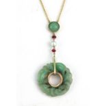 An 18ct yellow gold (stamped 750) necklace set with a carved jade amulet, rubies and pearls, L. 5.