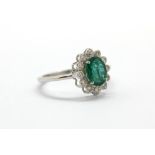 An 18ct white gold emerald and diamond set ring, approx. 1.21ct emerald, (O).