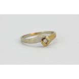 A 9ct yellow and white gold diamond set solitaire ring, (Q).