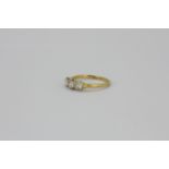 An 18ct yellow gold and platinum ring set with three brilliant cut diamonds, approx. 0.80ct overall,
