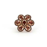 A 925 silver rose gold gilt ring set with garnets and black spinels, (O).