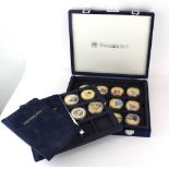 A box of sixteen commemorative enamelled coins with certificates.