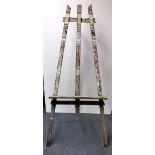 A large antique wooden artist's easel, W. 74cm, H. 180cm, understood to have originated from the