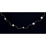 An 18ct yellow gold (stamped 750) pearl set necklace, L. 38cm.