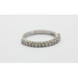 An 18ct white gold diamond set half eternity ring, (M).