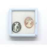 Two carved cameo beads.