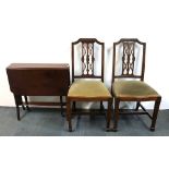 An Edwardian mahogany Pembroke table and two mahogany chairs.